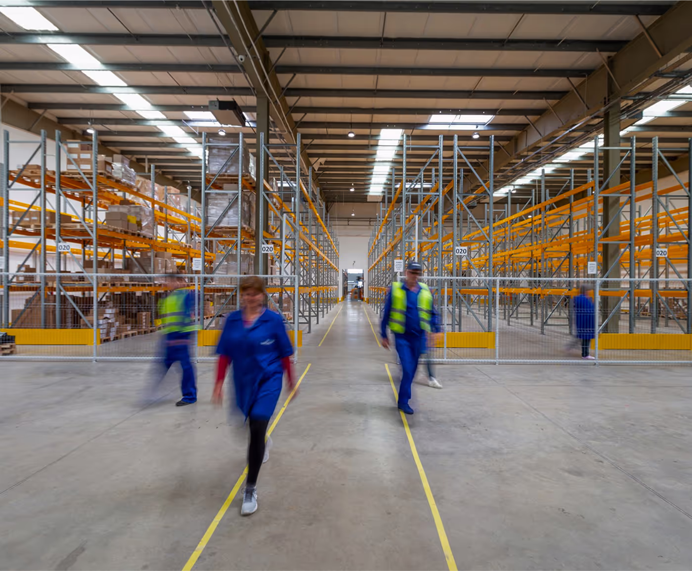image of workers walking inside a warehouse